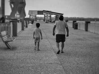 Rear view of people walking on street
