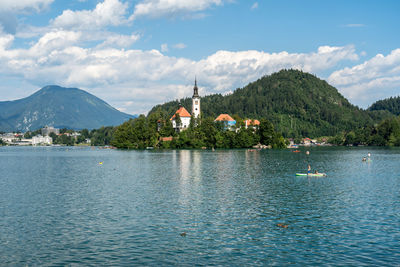 Scenic view of lake by building against sky