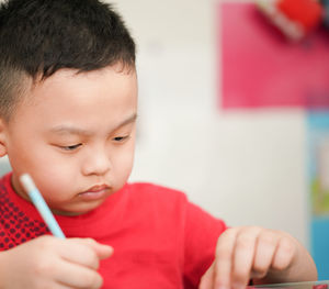 Close-up of girl drawing at home