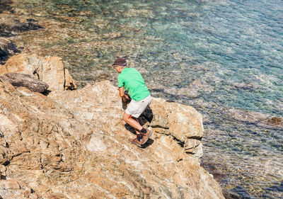 Full length of man climbing on rock