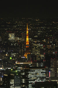 Illuminated cityscape against sky at night