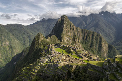 Scenic view of mountains against cloudy sky