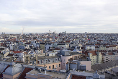 Cityscape against cloudy sky