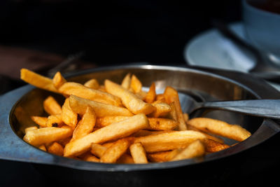 Close-up of french fries in plate on table