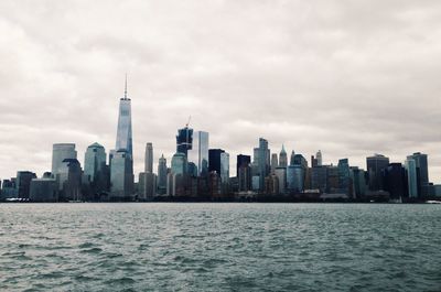 Sea and cityscape against sky