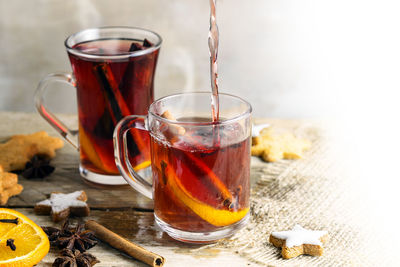 Close-up of tea pouring in cup on table