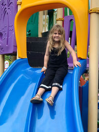 Portrait of baby girl sitting on slide
