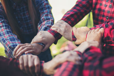 Cropped image of people forming hand chain