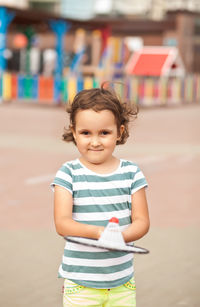 Portrait of smiling girl standing outdoors