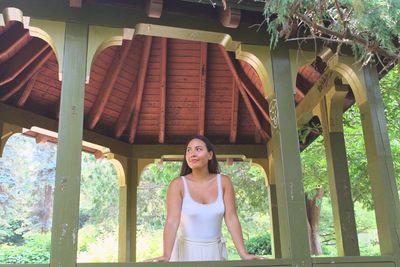 Young woman standing in gazebo at park