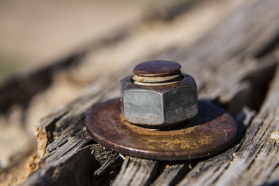 Close-up of rusty metal on wood