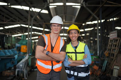 Portrait of woman standing in factory