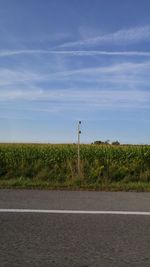 Road by landscape against sky