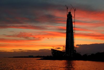 Scenic view of silhouette trees against orange sky