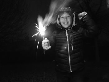 Portrait of smiling girl standing at night