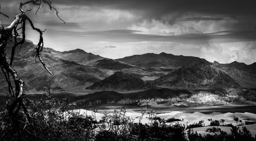 Scenic view of mountains against cloudy sky
