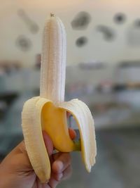 Close-up of person holding banana