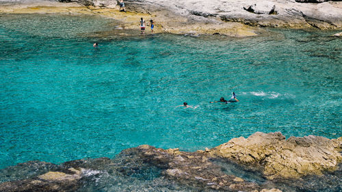 People swimming in sea