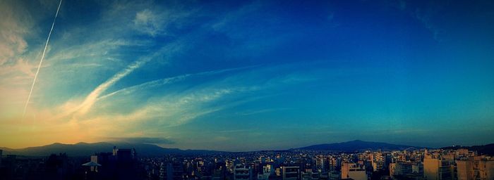 Cityscape against cloudy sky