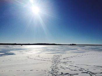 Scenic view of snow covered land against clear sky