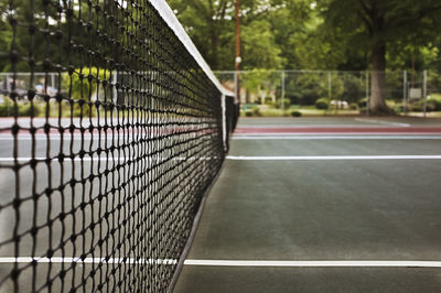 Close-up of net against trees in court