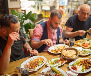 Group of people having food in restaurant