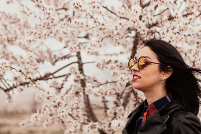 Portrait of beautiful young woman with cherry blossom