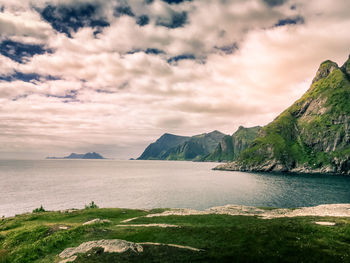 Scenic view of sea and mountains against sky