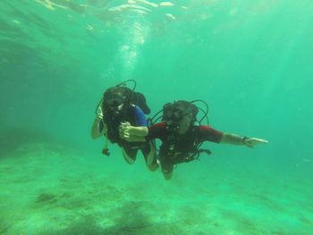 Men scuba diving in sea