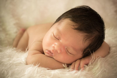 Cute baby boy sleeping on fur