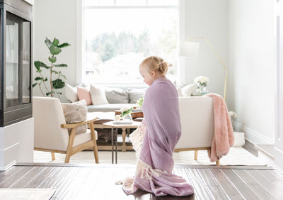 Blonde toddler girl in bright white house