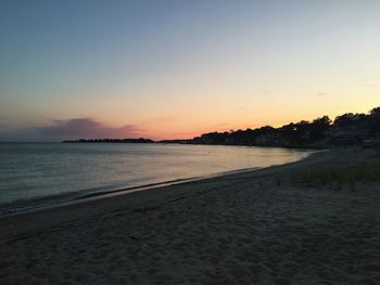 Scenic view of sea against clear sky during sunset
