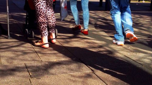 Low section of woman standing on tiled floor