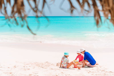 People sitting on shore at beach