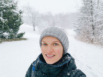 Portrait of smiling woman in snow