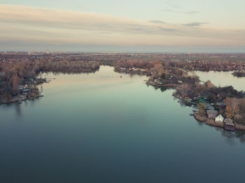 High angle view of lake against sky in city