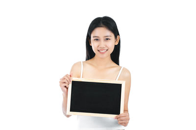 Portrait of a smiling young woman over white background