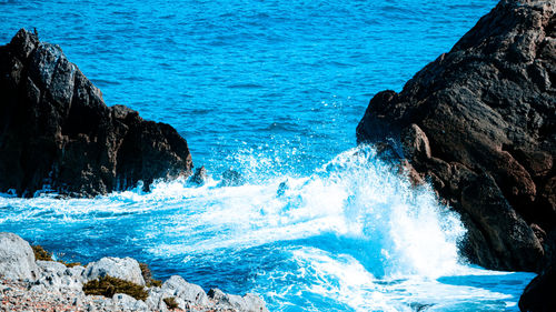 Sea waves splashing on rocks