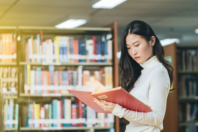 Young woman reading book