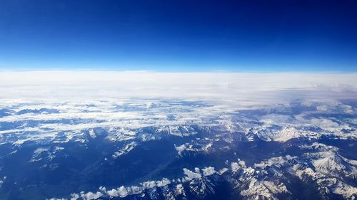 Aerial view of dramatic landscape against blue sky