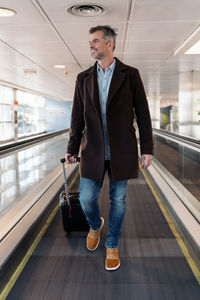 Full length of man standing in train