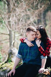 Young couple sitting outdoors