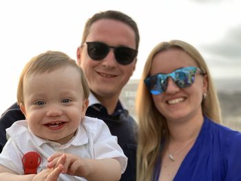 Portrait of smiling family against sky