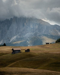 Scenic view of field and mountains against sky