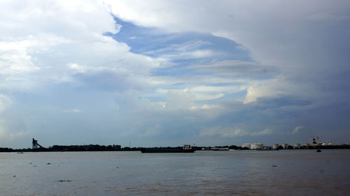 Scenic view of sea against cloudy sky