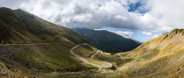 Scenic view of mountains against cloudy sky