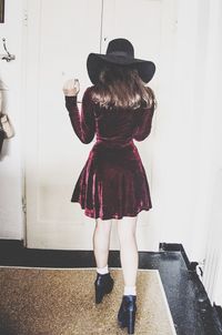 Full length of young woman standing by railing