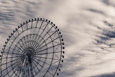 Low angle view of ferris wheel against sky