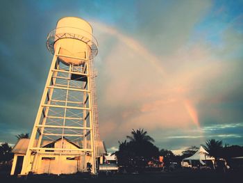 Low angle view of water tower against sky during sunset