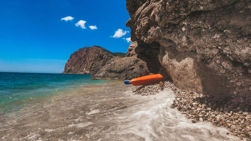 Scenic view of rock formation in sea against sky